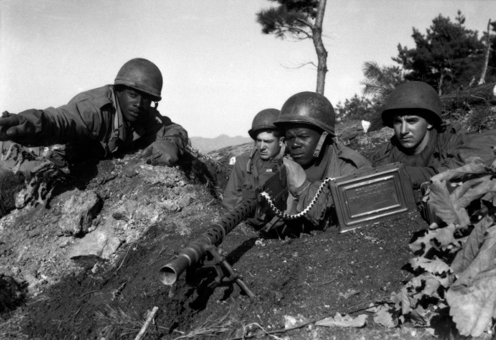 Fighting with the 2nd Inf. Div. north of the Chongchon River, Sfc. Major Cleveland, weapons squad leader, points out communist-led North Korean position to his machine gun crew.  November 20, 1950.  Pfc. James Cox. (Army) NARA FILE #:  111-SC-353469 WAR & CONFLICT BOOK #:  1426
